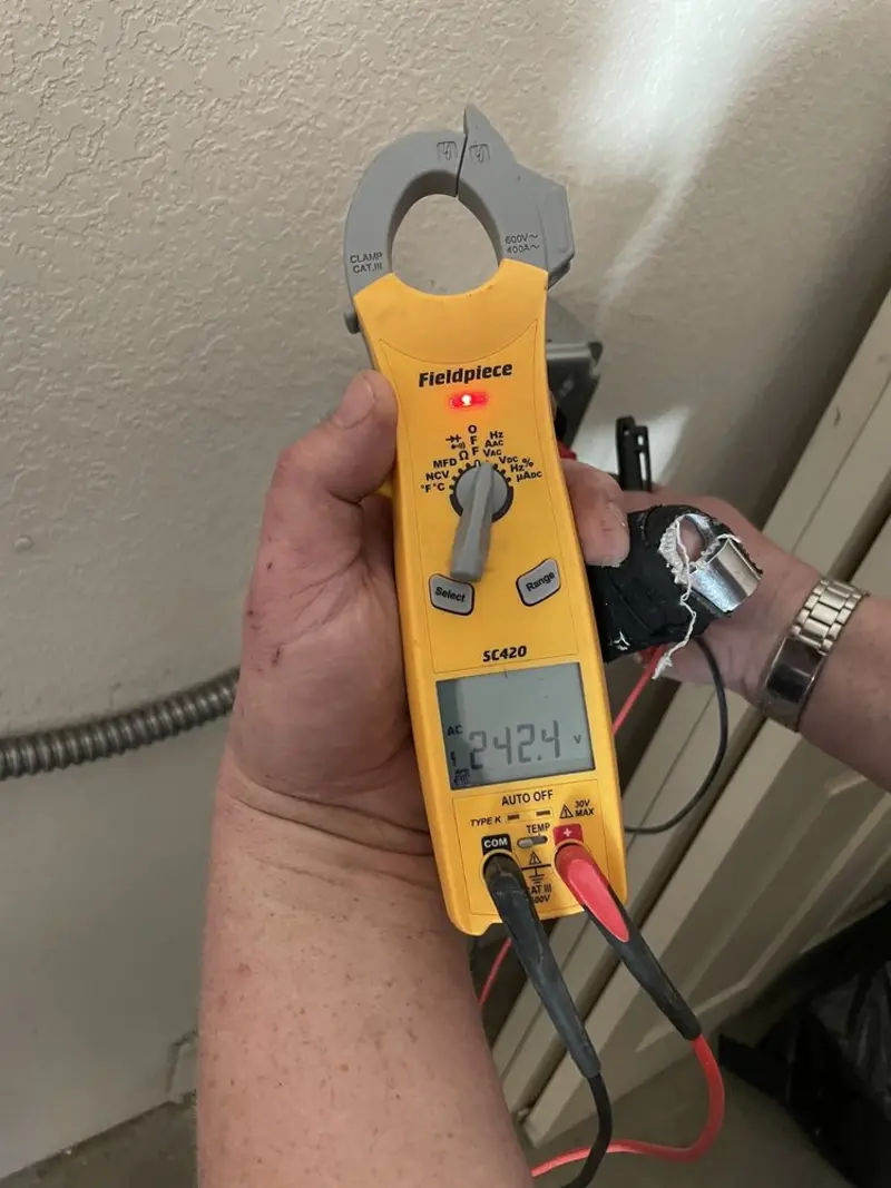 Voltage testing with clamp meter during Whole House Surge Protector in Barrington Hills